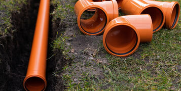 Laying,Down,Orange,Pvc,Drainage,Pipes,Into,The,Ground