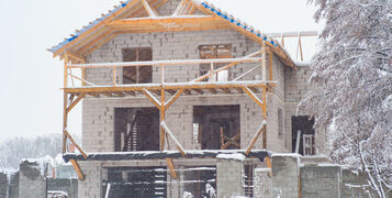 House,Under,Construction,During,Winter,Snowfall.,New,House,Construction,In