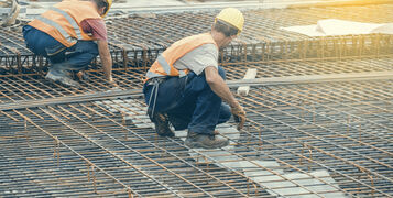 Ironworker,Workers,Working,On,Concrete,Reinforcements,At,Construction,Site.,Reinforcing