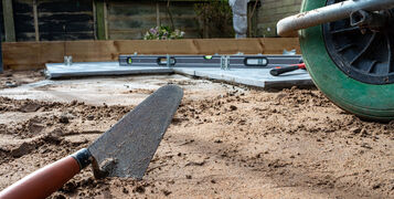 Trowel,Laying,On,The,Ground,Ready,To,Lay,A,Patio