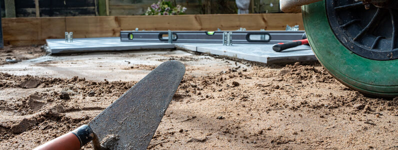 Trowel,Laying,On,The,Ground,Ready,To,Lay,A,Patio